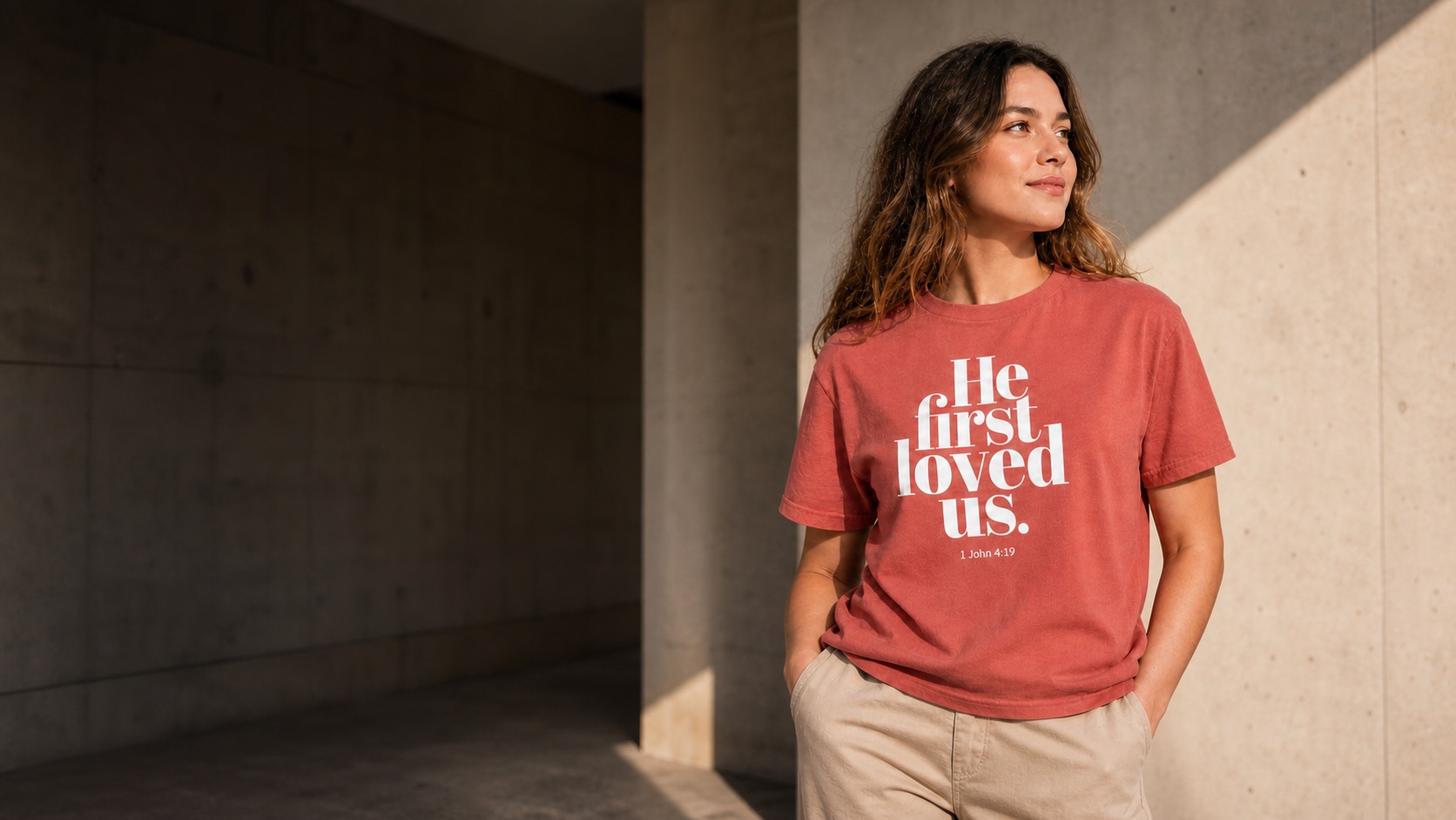 Woman wearing the He First Loved Us Scripture Brand T-shirt